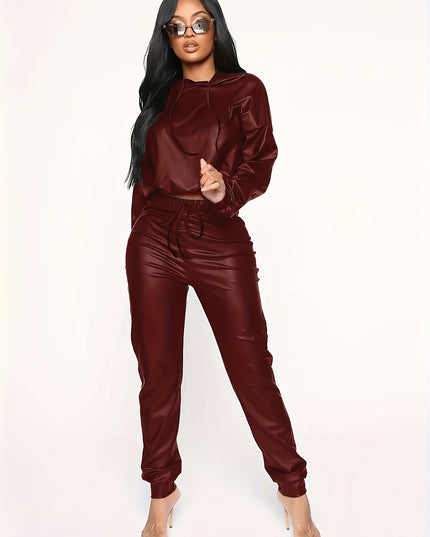 A Two-Piece Set Made of Solid Color Synthetic Faux Leather, Featuring an Off-Shoulder Cropped Hoodie And Drawstring Long Pants, Designed for Women.